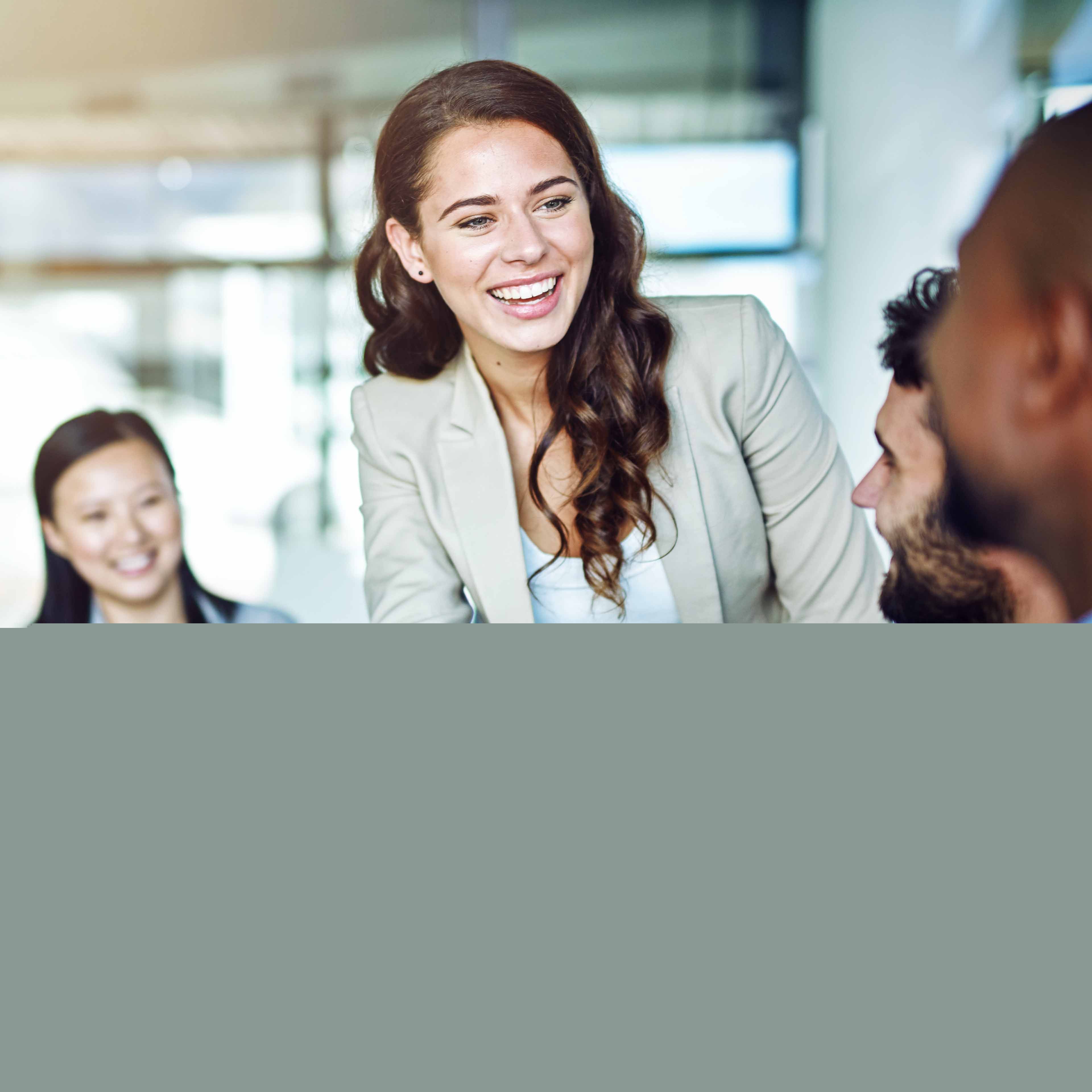 Elekta colleagues sat around a table shaking hands